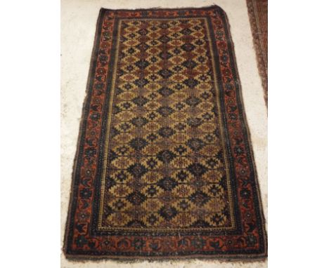 A Caucasian rug the central panel set with repeating tile decoration with blue, cream and red design within a stepped blue, r