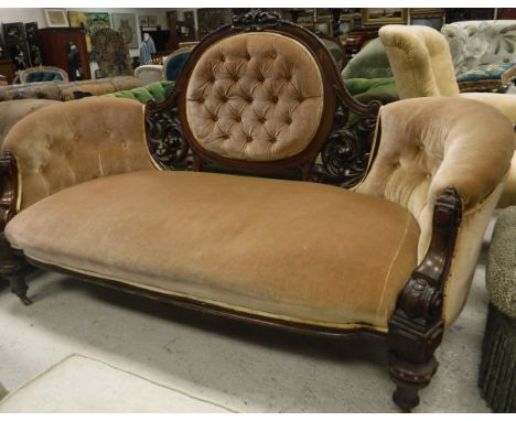 A Victorian walnut framed show frame salon sofa with carved decoration