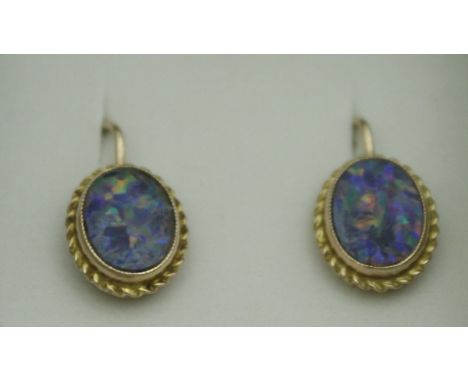 A pair of gold mounted opal set earrings