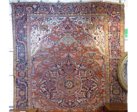 ANTIQUE HERIZ CARPET, 340cm x 236cm, of a sapphire medallion on terracotta field, ivory spandrels within sapphire border.