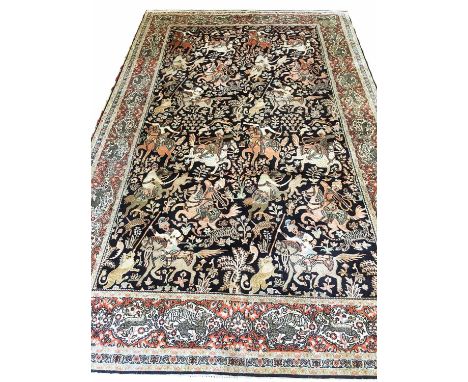 TEHRAN 'HUNTING' DESIGN CARPET, 280cm x 185cm, on sapphire field within border with ivory tiger and deer reserves.