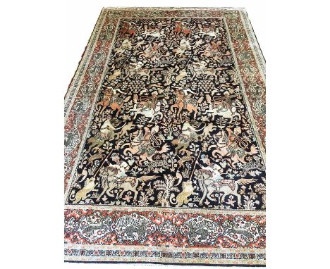 TEHRAN 'HUNTING' DESIGN CARPET, 280cm x 185cm, on sapphire field within border with ivory tiger and deer reserves.