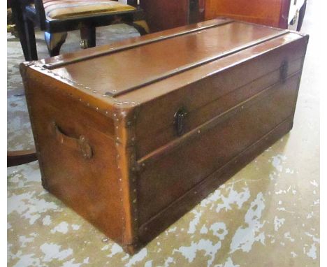 TRUNK, rectangular faux brown leather and wooden bound with a rectangular rising top enclosing space for storage and a handle