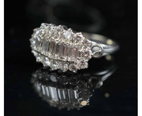 DIAMOND CLUSTER RING, the centre set with five graduated baguette cut diamonds within a surround of seventeen brilliant cut d