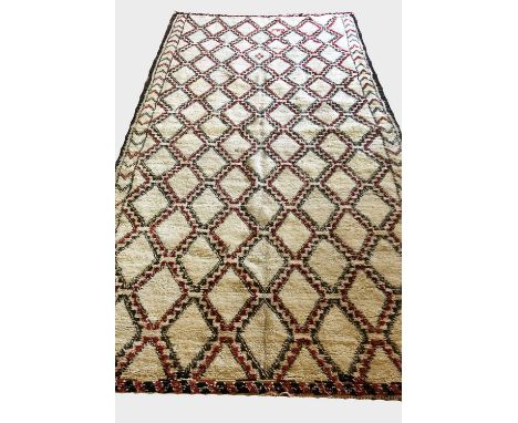 ANTIQUE BEN OURIAN BERBER MOROCCAN CARPET, 360cm x 190cm, of umber and ruby diamond pattern on ivory field. 