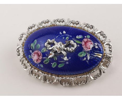 An Italian 18ct white gold and enamelled brooch by Unoaerre, the blue enamel with floral decoration and white gold bow, set w