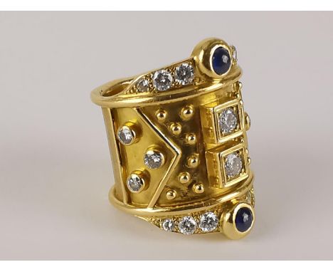 A vintage 18ct gold sapphire and diamond ring by Elizabeth Gage with two central diamonds, flanked by two cabochon sapphires,