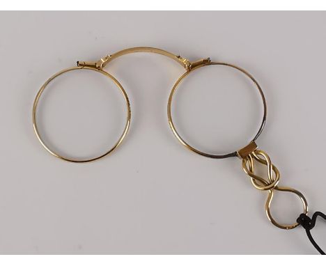 A pair of early 20th century gold Lorgnettes, with a knotted handle and manual mechanism 