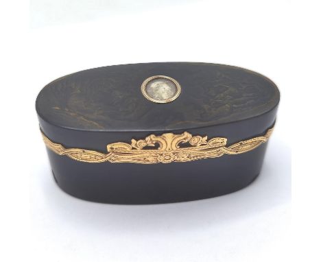An 19th century tortoise shell snuff box having a floral decorated gold border, with inset carved portrait cameo to the lid a