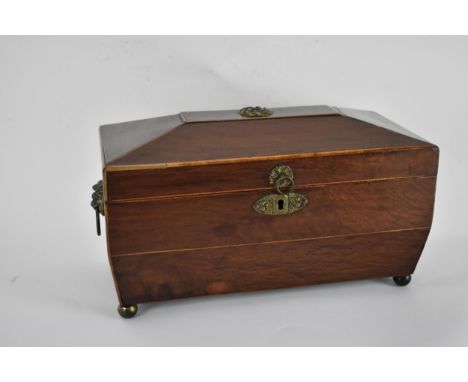 A Regency string inlaid Pollard tea caddy of sarcophagus form, with brass handles and mounts, the hinged lid enclosing a glas