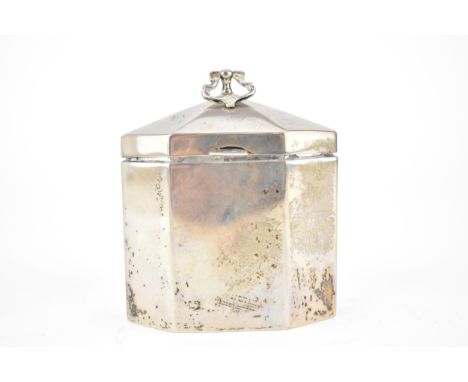 An Edwardian silver tea caddy by Walker &amp; Hall, Sheffield 1907, of octagonal form, with a hinged lid and handle, over str
