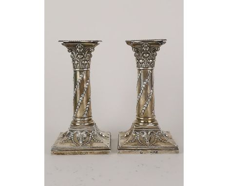 A pair of late Victorian silver Corinthian column candlesticks by William Hutton &amp; Sons, London 1898/1901, with deer head