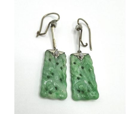 A pair of white gold and platinum drop earrings, each set with two diamonds and a carved Chinese jade panel, total weight 5.6
