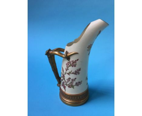 A Royal Worcester ewer, decorated with flowers and simulated horn handles