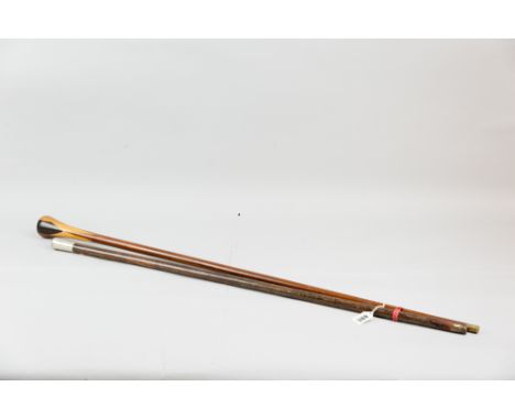 A wooden swagger stick with white metal top bearing the emblem for the Royal Fusiliers along with a multi-wood walking stick 