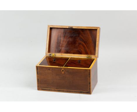 A Georgian mahogany tea caddy with rosewood crossbanding and boxwood stringing, twin mahogany lidded interior wells with ebon
