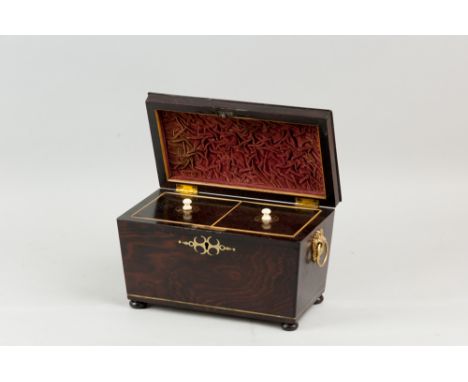 A 19th Century rosewood and ebony edged brass inlaid tea caddy with brass ring carrying handles raised on turned ebonized bun