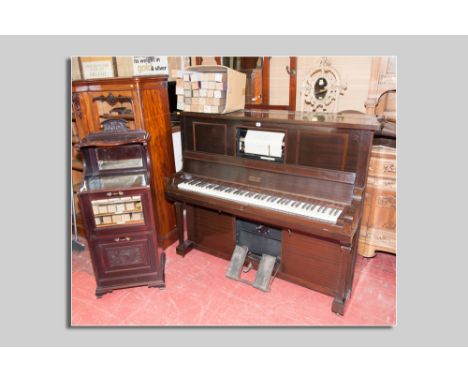 An early 20th Century upright pianola piano manufactured by the Aeolian Company Ltd, London along with forty plus music rolls