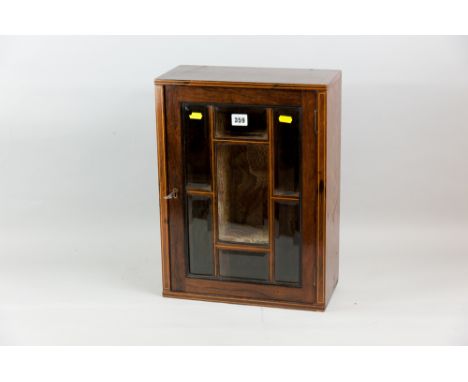 An Edwardian rosewood and boxwood line inlaid display cabinet, the single opening door with seven bevelled edge glass panels 