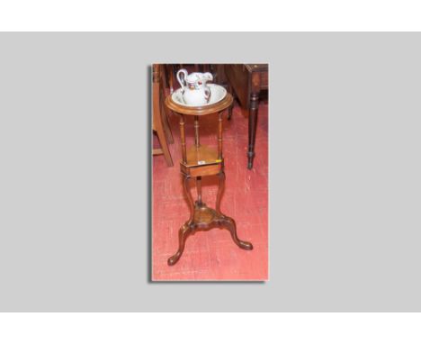 A small circular topped mahogany washstand with centre shelf and tiny drawer and a base shelf on three shaped supports and pa