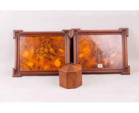 An octagonal rosewood trinket box with a dome topped lid having a ring handle and having an interior four section tray with l