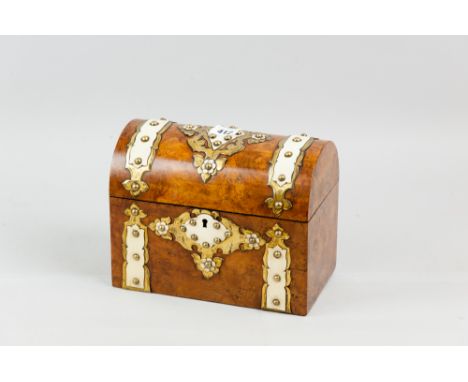 A Victorian walnut dome topped casket shaped tea caddy with Gothic style brass embellishments, overlaid with ivory/bone decor