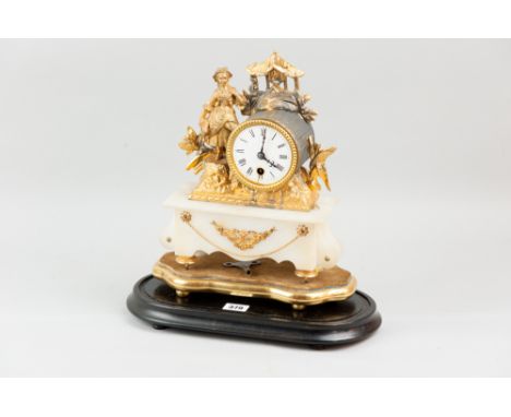 A gilt metal encased mantle clock, the drum dial flanked by a peasant female figurine on an alabaster base, eight day French 