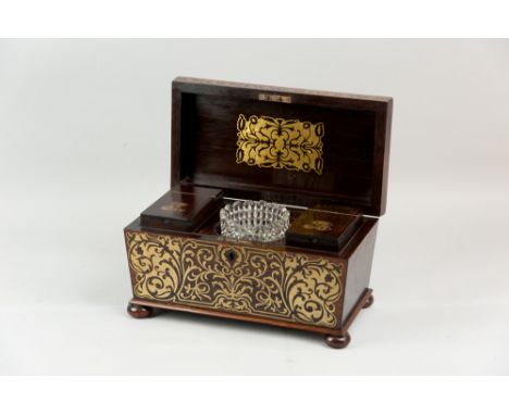 An excellent Regency, rosewood and brass inlaid tea caddy of sarcophagus form raised on turned bun feet, the lid opening to r