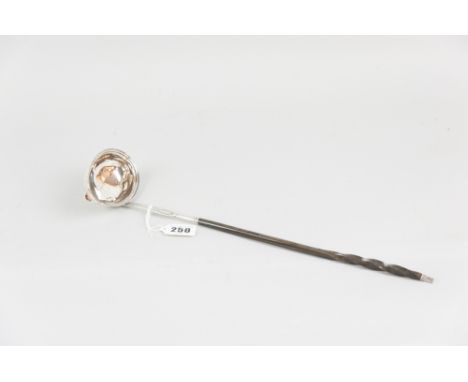 A Georgian silver ladle having an oval bowl with end lip and with a bright cut and shaped insert for the twist handle