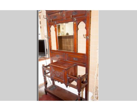 A good size Edwardian mahogany hallstand with carved chamfered panels, central bevelled edge mirror and brass acorn top coat 