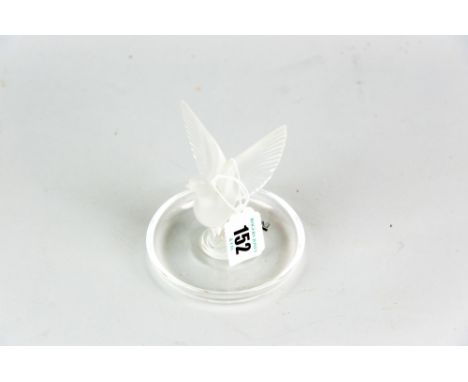 A Lalique clear glass pin tray with central pedestal surmounted by a frosted glass dove, engraved to the base 'Lalique France