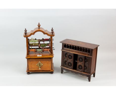 A 19th Century Dutch walnut and rosewood cabinet top thread or wool holder with single drawer raised on bun feet, the top sec