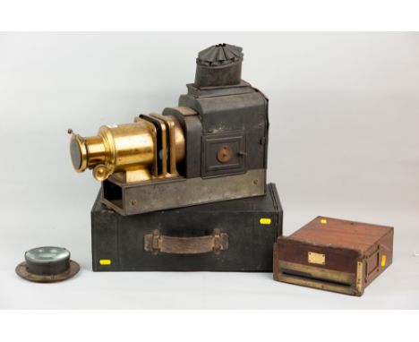 A tinware and brass Magic Lantern with tinware carry case (possibly associated), a brass mounted and glass lens and a mahogan