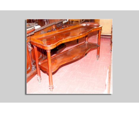 A fine mahogany serpentine front two tier serving waiter, the top having a narrow railback to a shaped bottom shelf and with 