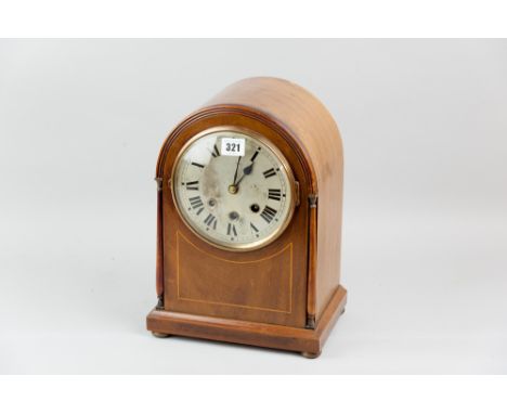 A late nineteenth/early twentieth century mahogany and inlaid domed top mantel clock, bevelled glass and brass bessel, silver