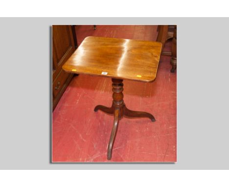 A Victorian mahogany tilt top tripod table, the near square top over a turned centre pedestal and three supports