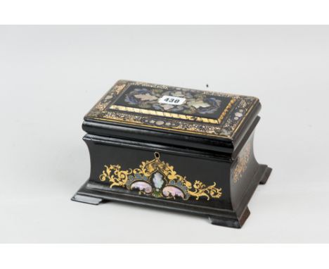 A 19th Century papier mache tea caddy of sarcophagus form inlaid with mother of pearl, enamel paint decoration and gilt highl
