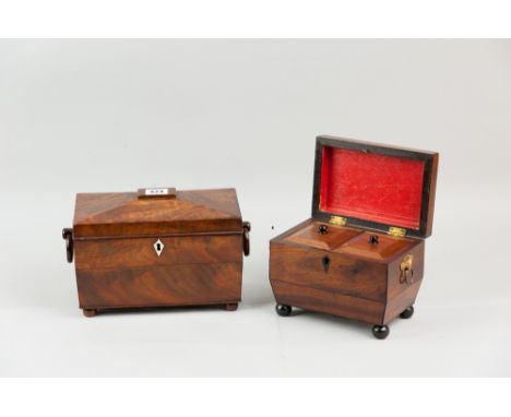 A 19th Century walnut sarcophagus shaped tea caddy with ivory escutcheon, turned wood ring handles, raised on turned bun feet