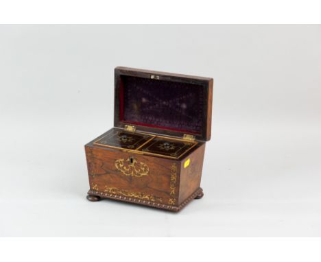 A 19th Century rosewood and brass inlaid tea caddy of sarcophagus form with bead moulded base on turned wooden bun feet (one 