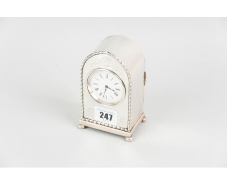 A fine quality dome topped silver encased mantle clock, the front having dart edging with bright cut floral scrolls on four b