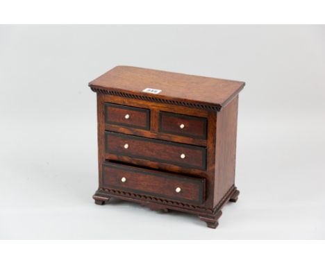 An oak and mahogany apprentice chest of two short and two long drawers, mahogany drawer fronts with ebony crossbanding and iv