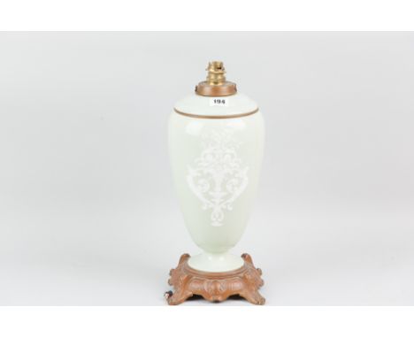 A large Celadon baluster shaper table lamp with Pate-Sur-Pate style decoration and angelic figure and a classical vase of flo