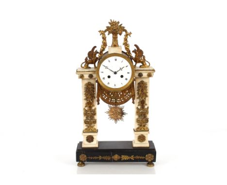 A 19th Century French marble and Ormolu mounted mantel clock surmounted by griffins and garlands above a circular Roman numer