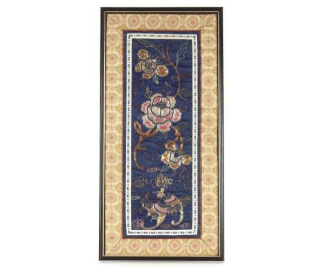 A framed and glazed Chinese embroidered section of a Mandarin's cloak decorated flowers and dragons, 61.5cmx 28.5cm