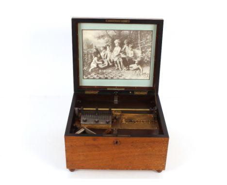 A Symphonion table model polyphon, in walnut case inscribed "Note Tune Plaque No. 48" and a Symphonion walnut case containing