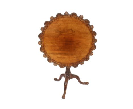 A 19th Century carved mahogany tripod occasional table, the shaped shell decorated top raised on a birdcage and fluted balust