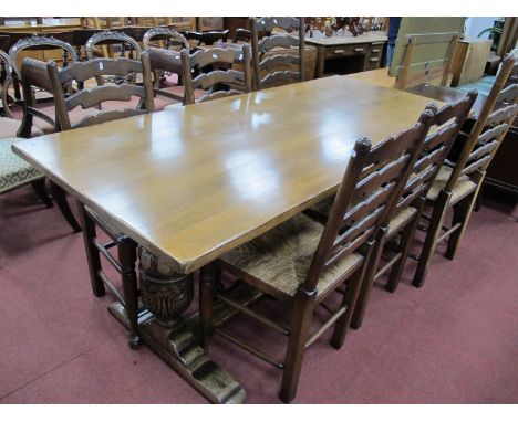 A XX Century Oak Refectory Table, on cup-cover supports, central stretcher, together with a set of six (two armchairs, four s