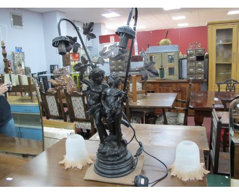 An Art Nouveau Style Table Lamp, featuring two maidens, and two bell glass shades.