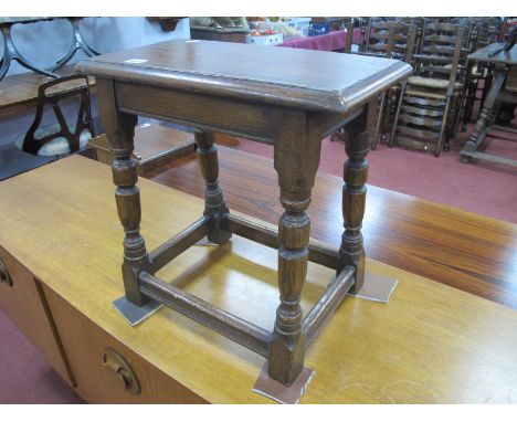 A XVII Style Oak Coffin Stool, with a moulded edge, on turned and block supports, with stretchers, 47cm wide.