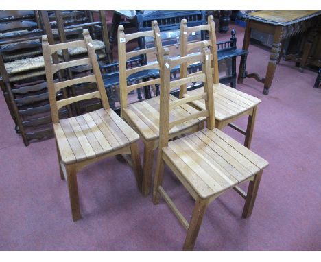 A Set of Four Oak Ladder Back Chairs, with solid seats, on square reeded supports.